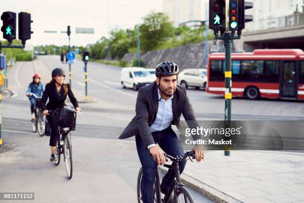 people cycling on street in city - public transport stock-fotos und bilder