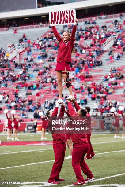 Cheerleaders of the Arkansas Razorbacks warming up before a game against the Mississippi State Bulldogs at Razorback Stadium on November 18, 2017 in...