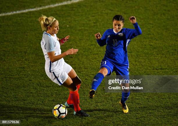 Stephanie Houghton of England battles for the ball with Saule Karibayeva of Kazakhstan during the FIFA Women's World Cup Qualifier between England...