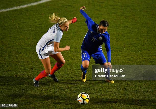 Stephanie Houghton of England battles for the ball with Saule Karibayeva of Kazakhstan during the FIFA Women's World Cup Qualifier between England...