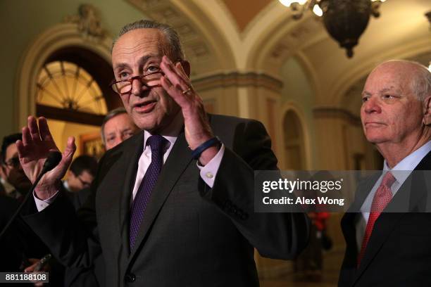 Senate Minority Leader Sen. Chuck Schumer speaks as Sen. Ben Cardin looks on during a news briefing after a weekly Senate Democratic Policy Luncheon...