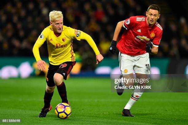 Watford's English midfielder Will Hughes runs with the ball chased by Manchester United's Serbian midfielder Nemanja Matic during the English Premier...