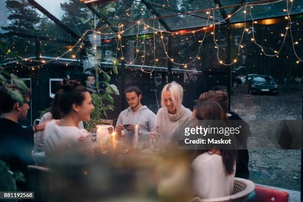 happy young friends having dinner party in cabin - garden party stock pictures, royalty-free photos & images
