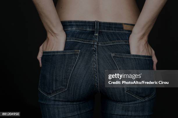 woman wearing jeans, hands in back pockets - back pocket stock pictures, royalty-free photos & images