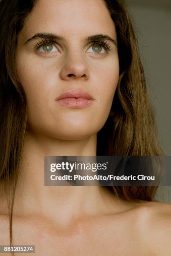 Young woman looking up in thought, portrait Young woman looking up in thought, portrait