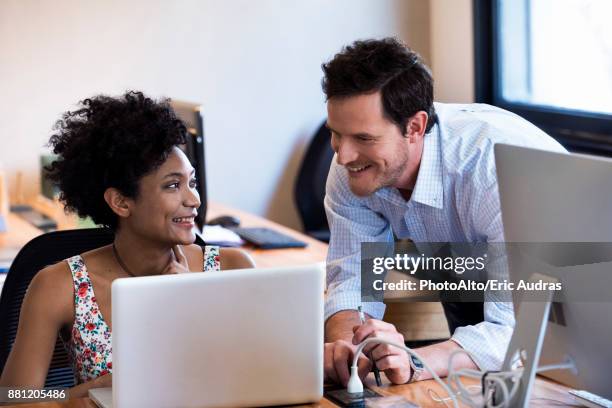 colleagues chatting in office - 2 men chatting casual office stock-fotos und bilder