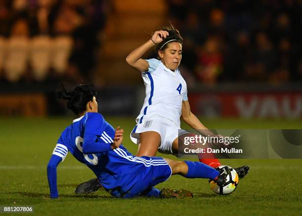 Fara Williams of England is tackled by Begaim Kirgizbaeva of Kazakhstan during the FIFA Women's World Cup Qualifier between England and Kazakhstan at...