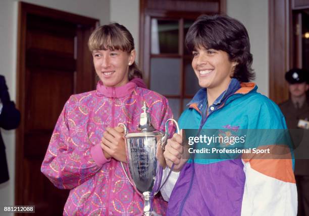 Doubles partners Gigi Fernandez of the USA and Natasha Zvereva of Belarus pose with the trophy after defeating Larisa Neiland of Latvia and Jana...