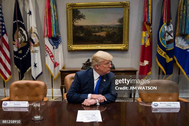 President Donald Trump makes a statement from the Roosevelt Room next to the empty chairs of Senate Minority Leader Chuck Schumer , D-New York, and...