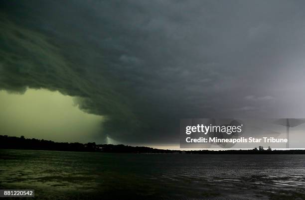 Severe thunderstorm rolls east towards downtown Minneapolis, lower right, seen from the south side of Lake Harriet on Sunday, June 11, 2017 in...