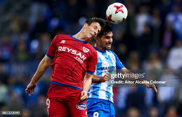 Adrian Gonzalez of Malaga CF duels for the ball with Guillermo Fernandez of Numancia during the Copa del Rey match between Malaga CF and Numancia at...