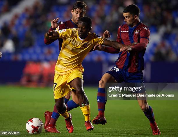 Jose Gomez Campana and Sergio Postigo of Levante competes for the ball with Marlos Moreno of Girona during the Copa del Rey, Round of 32, Second Leg...