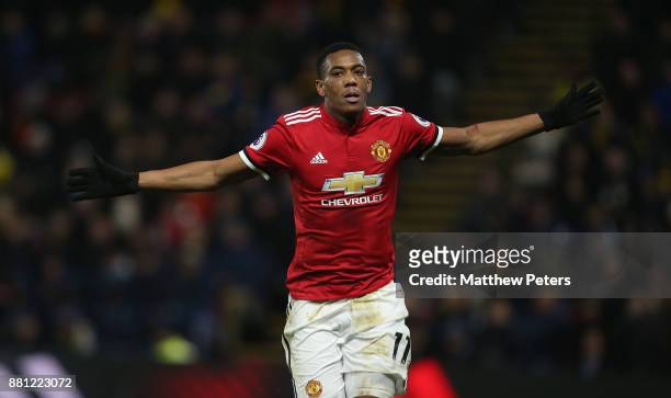 Anthony Martial of Manchester United celebrates scoring their third goal during the Premier League match between Watford and Manchester United at...