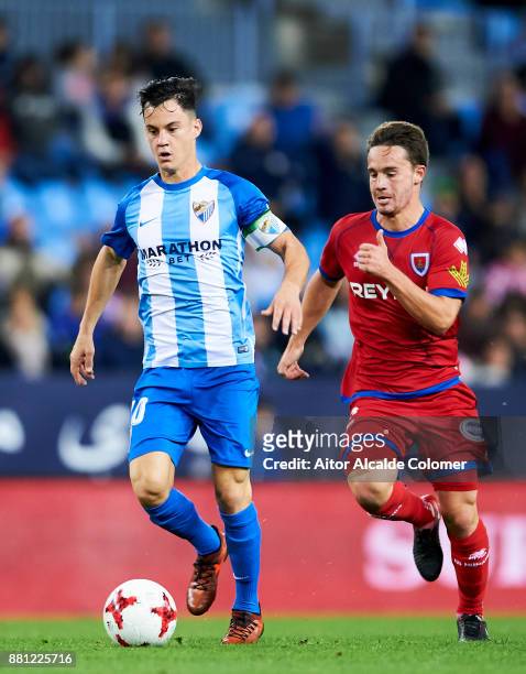 Juan Pablo Anor "Juanpi" of Malaga CF duels for the ball with Pablo Larrea of Numancia during the Copa del Rey match between Malaga CF and Numancia...