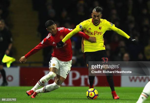 Marcos Rojo of Manchester United challenges Roberto Pereyra of Watford on his way to conceding a penalty during the Premier League match between...