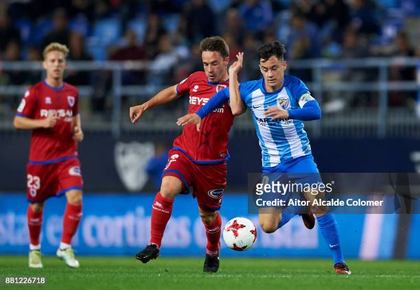 Juan Pablo Anor "Juanpi" of Malaga CF duels for the ball with Pablo Larrea of Numancia during the Copa del Rey match between Malaga CF and Numancia...
