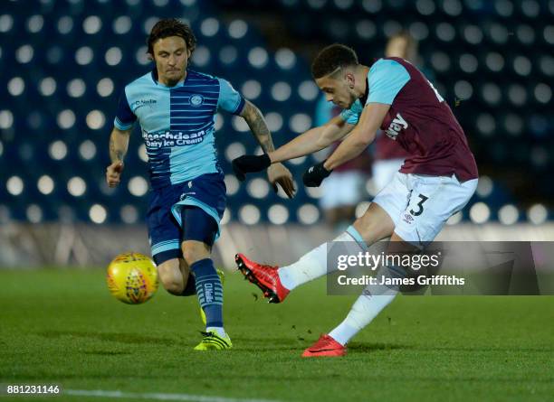 Marcus Browne of West Ham United in action with Sam Saunders of Wycombe Wanderers during the Checkatrade Trophy match between Wycombe Wanderers and...