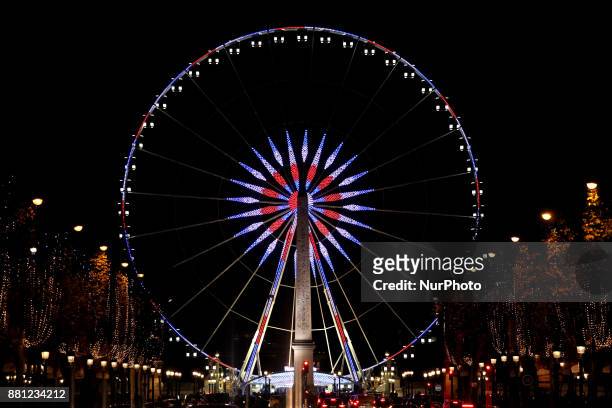 View of the ferris wheel at 'Place de la Concorde' next to Champs-Elysees at night during Christmas illuminations in Paris, France on November 25,...