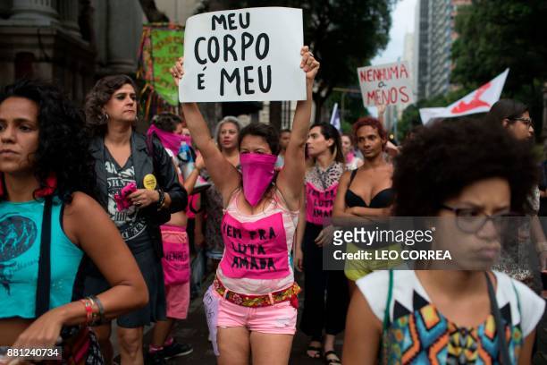 Women wear pink masks protesting the violence against women in Rio de Janeiro, Brazil, on November 28, 2017. Around 100 people gathered in a march...