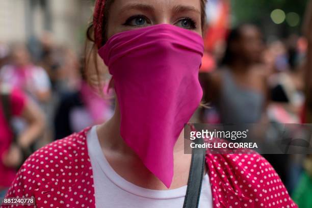 Women wear pink masks protesting the violence against women in Rio de Janeiro, Brazil, on November 28, 2017. Around 100 people gathered in a march...