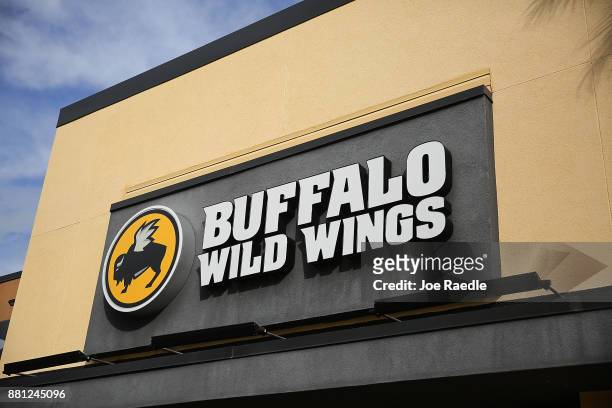 Sign is seen on a Buffalo Wild Wings restaurant on November 28, 2017 in Miami, Florida. Today, Arby's Restaurant Group announced it reached a deal to...
