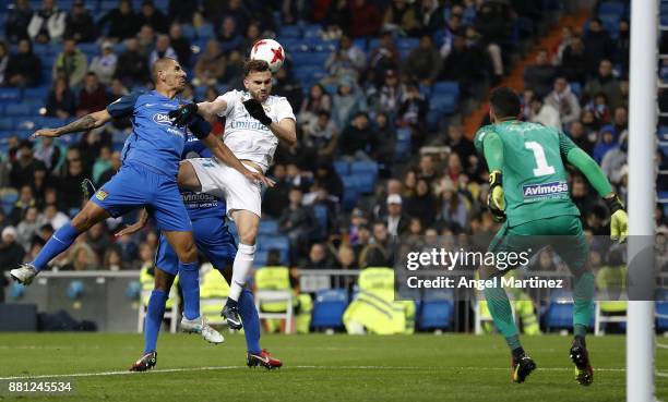 Borja Mayoral of Real Madrid competes for the ball with Cata Diaz of Fuenlabrada during the Copa del Rey round of 32 second leg match between Real...