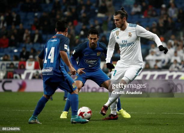 Gareth Bale of Real Madrid in action against Juan Quero Barraso and Cristobal of Fuenlabrada during the King's Cup soccer match between Real Madrid...