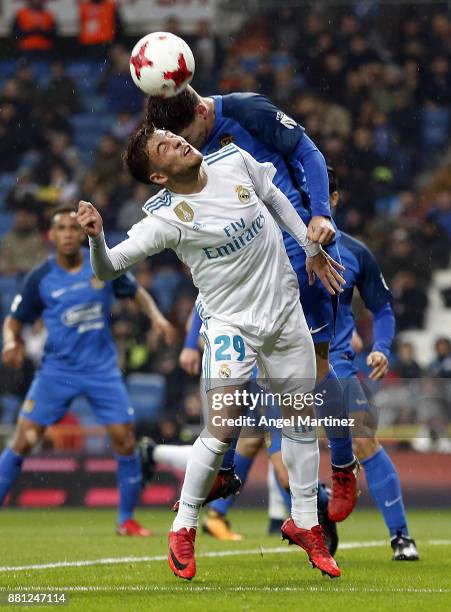 Francisco Feuillassier of Real Madrid competes for the ball with Fran Garcia of Fuenlabrada during the Copa del Rey round of 32 second leg match...