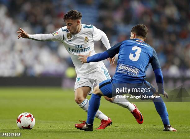 Francisco Feuillassier of Real Madrid competes for the ball with Fran Garcia of Fuenlabrada during the Copa del Rey round of 32 second leg match...