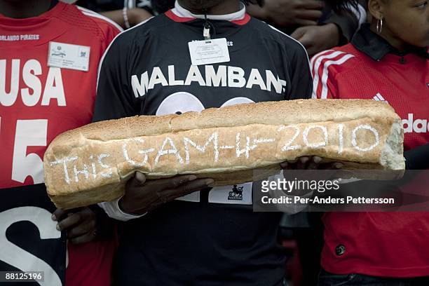 Supporter for the local team Orlando Pirates holds a big loaf of bread on May 2, 2009 at Johannesburg Stadium, Johannesburg, South Africa. About...