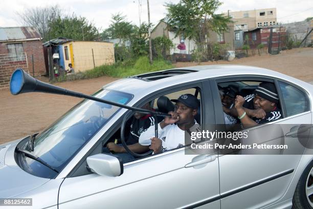 Orlando Pirates soccer supporters leave for a game in a car on May 9 in Soweto, South Africa. Diehard fans usually dress up before attending games....