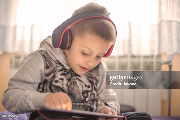 siblings - bonding - electronic listening device stock pictures, royalty-free photos & images