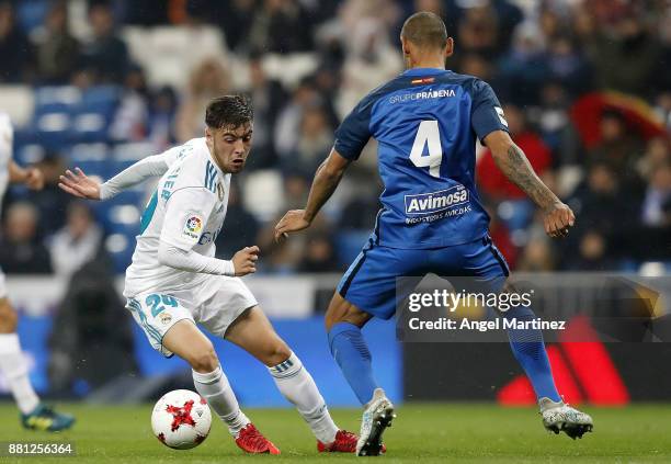 Francisco Feuillassier of Real Madrid competes for the ball with Cata Diaz of Fuenlabrada during the Copa del Rey round of 32 second leg match...