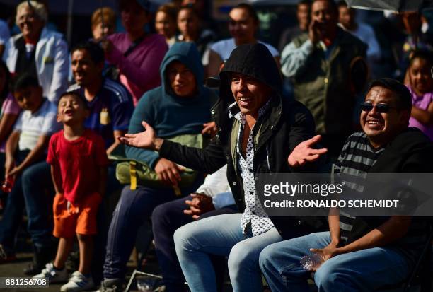 Locals enjoy an open-air championship of Mexican wrestlers in in the poor neighborhood of Tepito, on November 28, 2017. The heart of Tepito, one of...