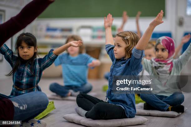 stretching-übung - children yoga stock-fotos und bilder