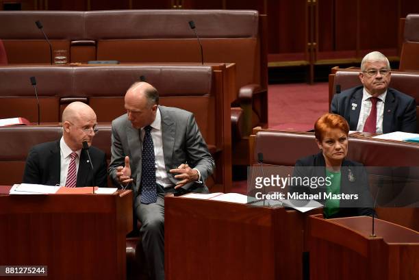 Senators David Lyonhjelm and Eric Abetz in discussion during the debate of the marriage equality bill in the Senate at Parliament House on November...