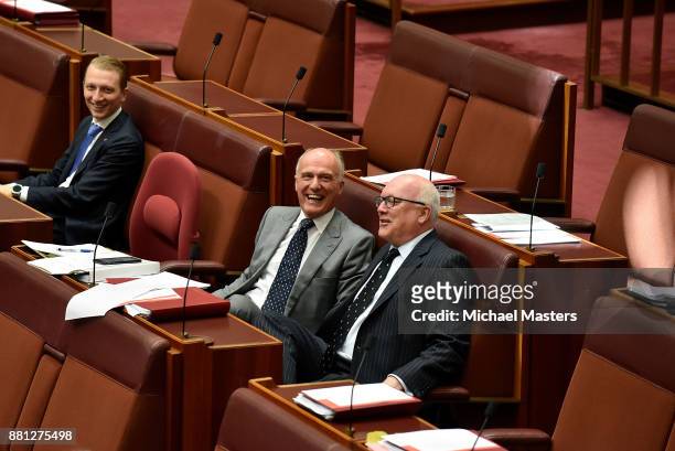 Sentors George Brandis , Eric Abetz and James Paterson share a lighter moment during the debate of the marriage equality bill in the Senate at...