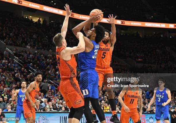 Duke forward Marvin Bagley III shoots over Florida guard Egor Koulechov and Florida guard KeVaughn Allen in the championship game of the Motion...