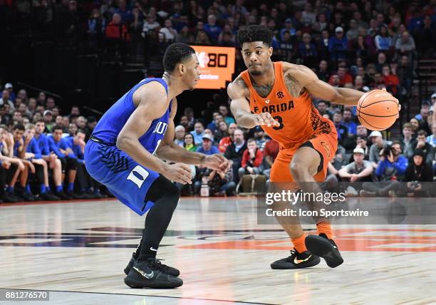 Florida guard Jalen Hudson dribbles past Duke guard Trevon Duval in the championship game of the Motion Bracket at the PK80-Phil Knight Invitational...