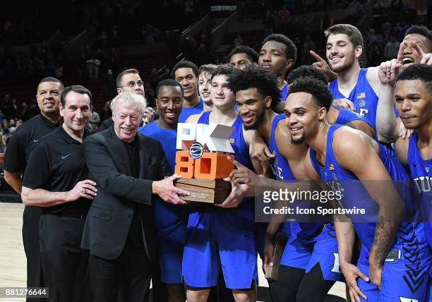 Nike chairman and co-founder Phil Knight presents the Duke Blue Devils with the Motion Bracket championship trophy at the PK80-Phil Knight...