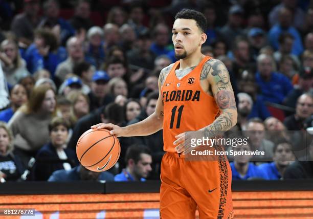 Florida guard Chris Chiozza brings th eball up court in the championship game of the Motion Bracket at the PK80-Phil Knight Invitational between the...