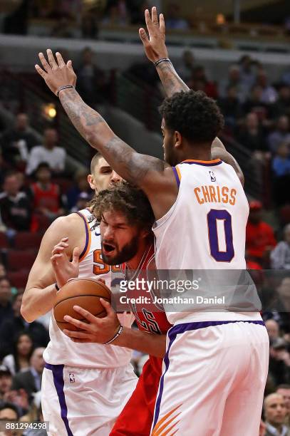 Robin Lopez of the Chicago Bulls tries to move between Alex Len and Marquese Chriss of the Phoenix Suns at the United Center on November 28, 2017 in...