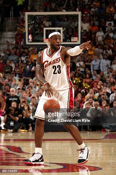 LeBron James of the Cleveland Cavaliers points as he moves the ball up court in Game Five of the Eastern Conference Finals against the Orlando Magic...