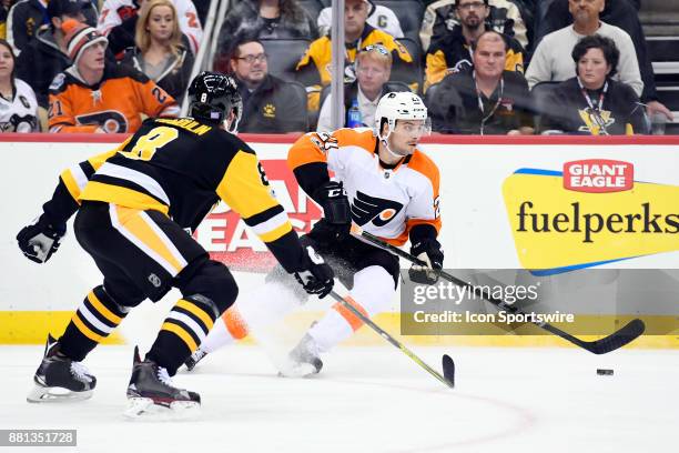 Philadelphia Flyers Center Scott Laughton handles the puck in front of Pittsburgh Penguins Defenseman Brian Dumoulin during the third period in the...