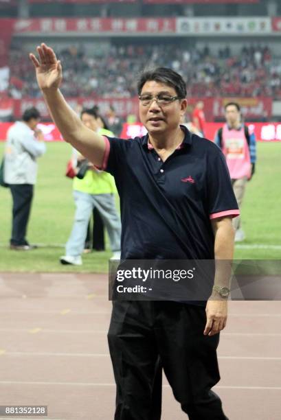 This photo taken on September 2, 2014 shows Xu Genbao, the man widely known as "Shanghai's godfather of football", waving after the CSL football...