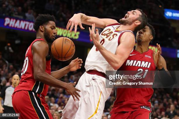Kevin Love of the Cleveland Cavaliers is fouled while taking a shot between Hassan Whiteside and Justise Winslow of the Miami Heat during the second...