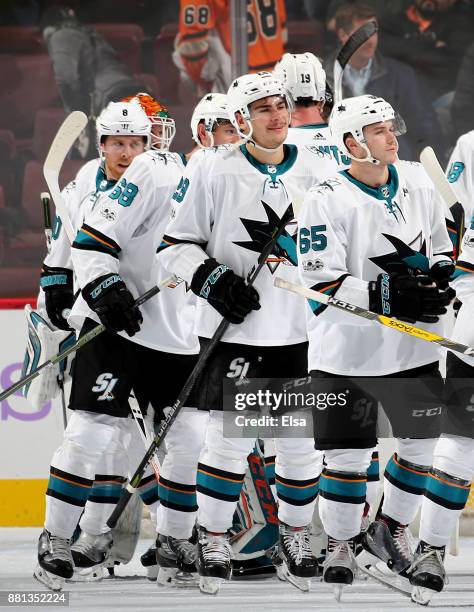 Daniel O'Regan and Timo Meier of the San Jose Sharks celebrate the 3-1 win over the Philadelphia Flyers with teammates after the game on November 28,...