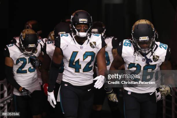 Strong safety Barry Church of the Jacksonville Jaguars leads teammates onto the field before the NFL game against the Arizona Cardinals at the...