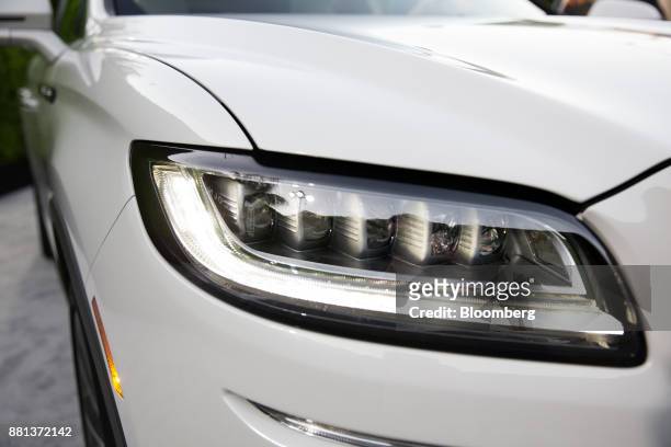 The headlight of a Ford Motor Co. Lincoln Nautilus sport utility vehicle is seen during an event in Los Angeles, California, U.S., on Monday, Nov....