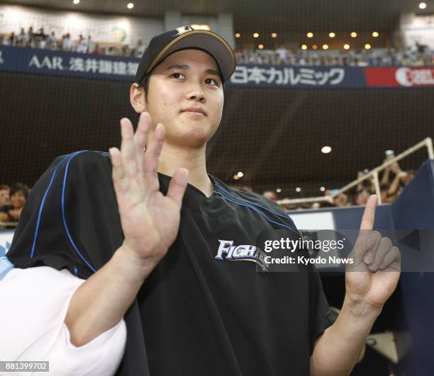 Shohei Otani of the Nippon Ham Fighters celebrates his 15th win of the 2015 season after striking out 12 over eight innings against the Orix...